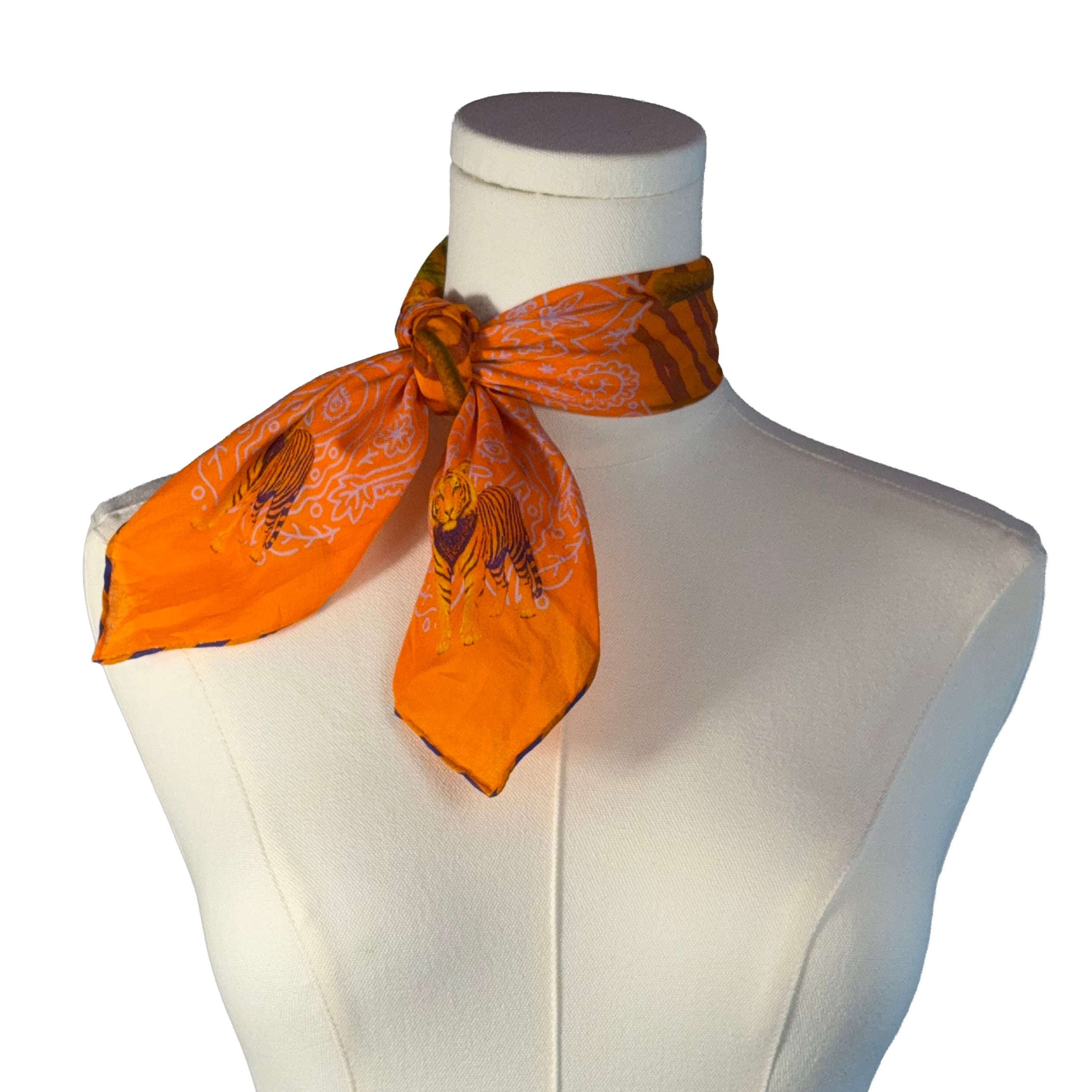 Orange scarf with a pattern on a mannequin bust against a white background
